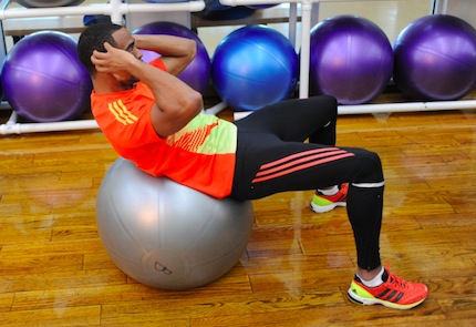 Sprinter Tyson Gay performing Stability Ball Sit-Ups during Olympic training. 
