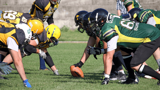 football lineman lined up on the line during a game