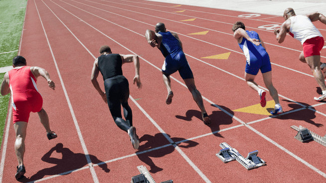 group of male sprinters on the track competing