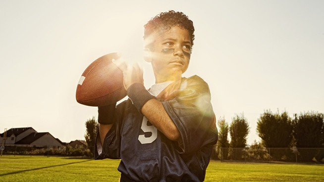 A portrait of a young flag football quarterback.