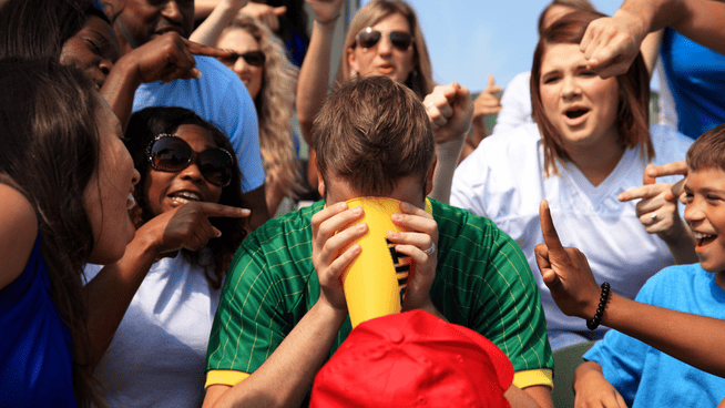 adults fans yelling at youth athlete at sporting event