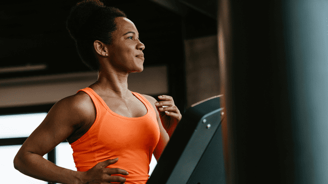 athletic african american woman jogging on treadmill at the gym - why do you exercise?