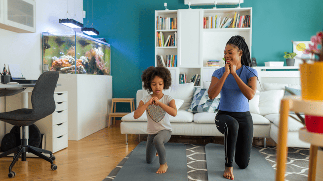 young girl and mother practicing lunges in living room - balance training
