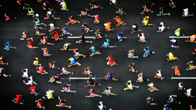 overhead image of marathon run with hundreds of runners - marathon recovery