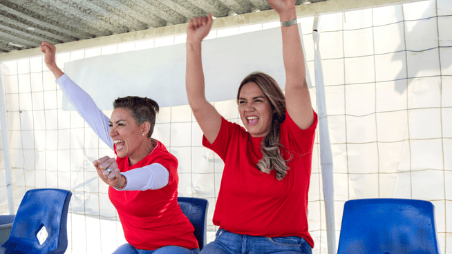 parents cheering from stands or bleachers at youth sporting event - sportsmanship for parents