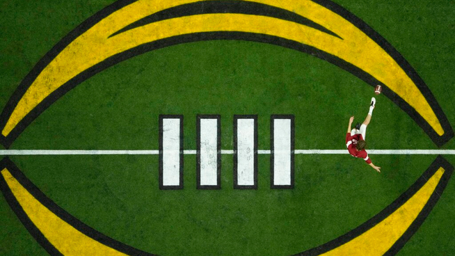 ncaa college football playoff logo in the middle of football field - expanding college football playoff
