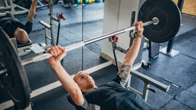 man bench pressing at the gym
