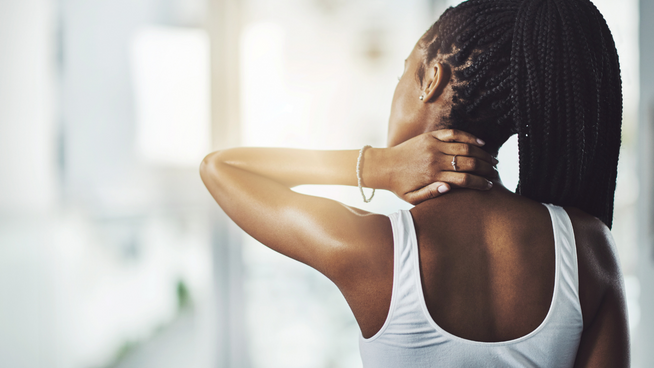 Woman grabbing neck in pain as she experience inflammation