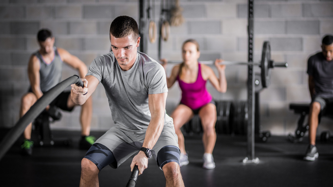 multiple people working out in weight room