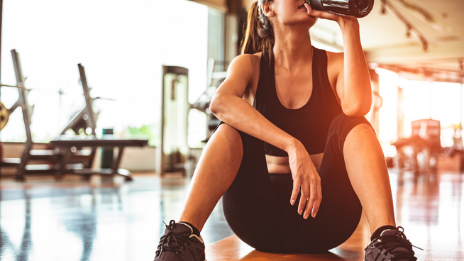 athletic woman resting after workout at the gym for her sports recovery
