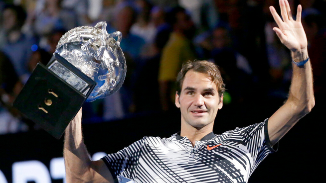 Roger federer holding trophy and waving goodbye for his retirement