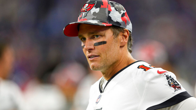 tom brady in tampa bay buccaneers jersey and hat on sideline
