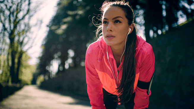 athletic woman resting during a jog outdoors