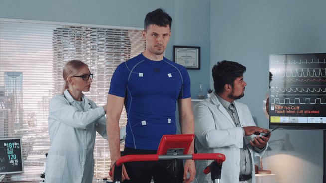 sports scientists studying male athlete on treadmill