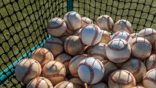 a large basket full of baseballs