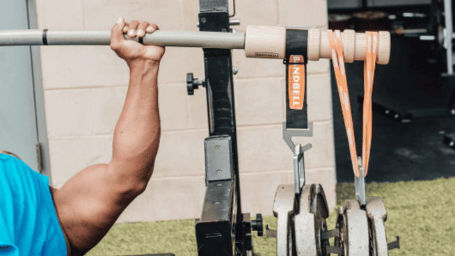 male bench pressing with an earthquake bar