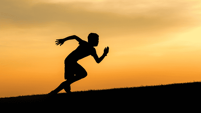 shadow of youth athlete sprinting outside