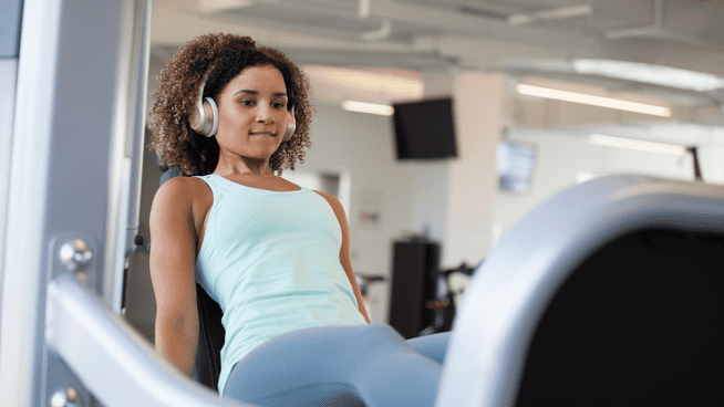 woman working out legs on machine at the gym