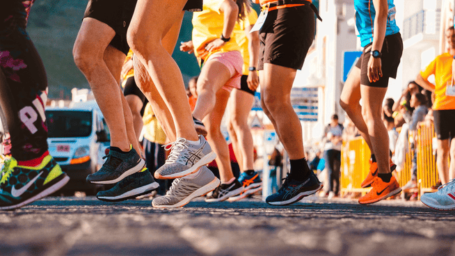 image of runners lower bodies and running shoes at a race