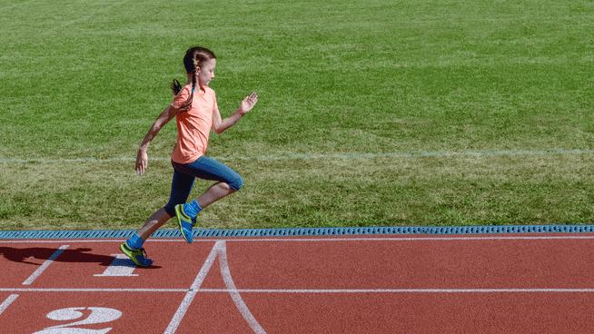 young girl practicing sprint training on track outside