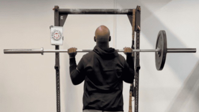 trainer lifting with uneven barbell