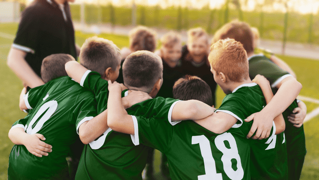 youth boys soccer team in huddle before game