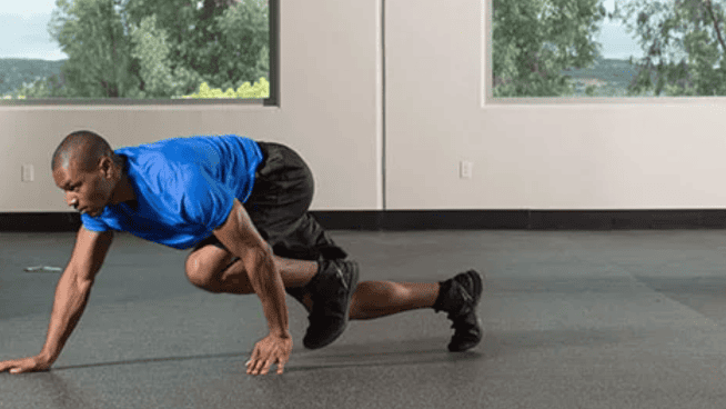 male athlete performing a bear crawl exercise