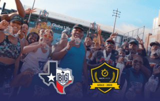 press release image for Big Texas Run in Arlington, TX with runners celebrating with their medals in front of Globe Life Field